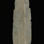 Back view of a capsule-shaped jadeite pendant colored gray, tan, and light green.