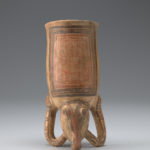 Back view of ceramic drinking vessel resembling a piglike animal, positioned upright on its front arms and snout.
