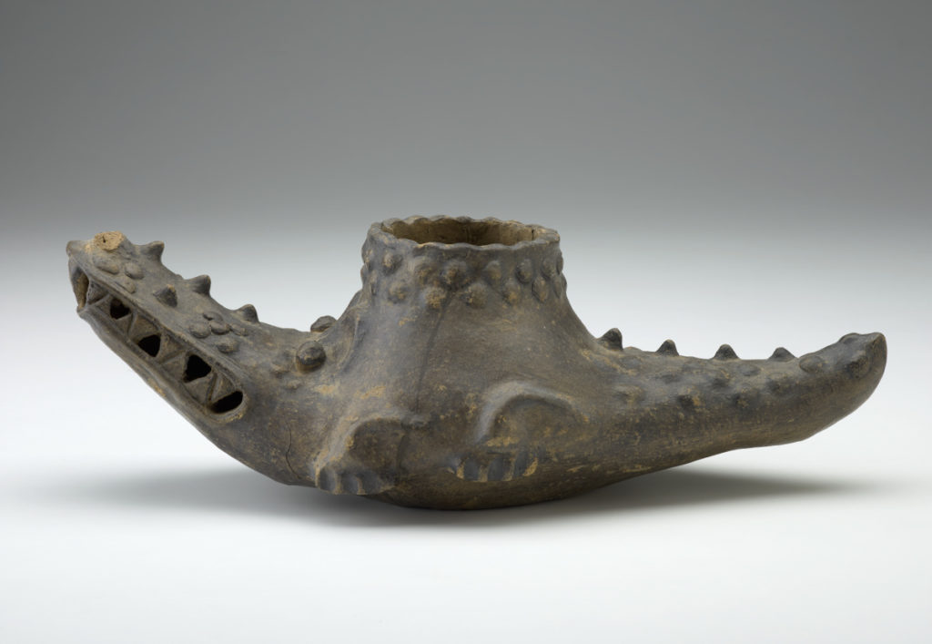 A crocodile-shaped ceramic vessel.