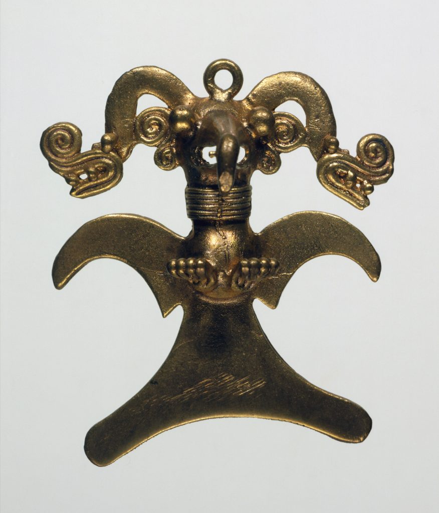 A gold pendant of an eagle wearing a headdress.