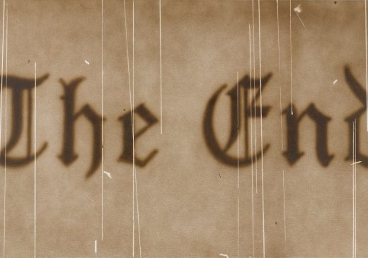 A painting of the words “The End” is textured to look like an old, scratched, sepia film still.
