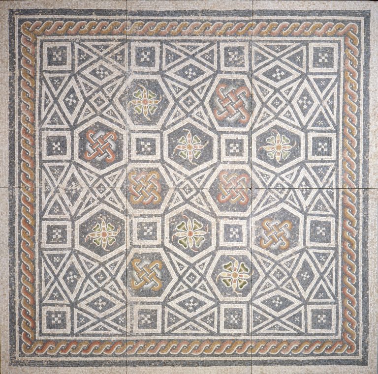 Square mosaic floor made of white marble pieces and colored glass, organized to create floral desgins and geometric patterns.