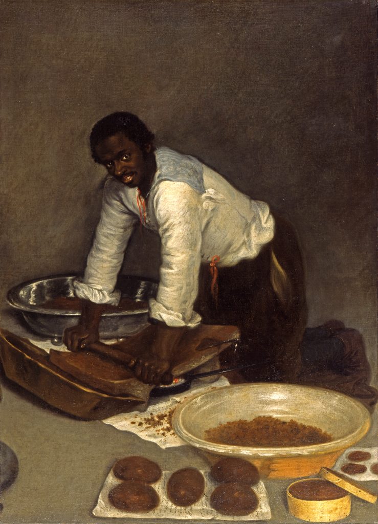A Man Scraping Chocolate Spanish