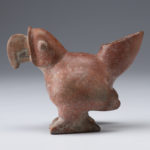 Side view of a reddish-brown ceramic vessel shaped like a parrot.