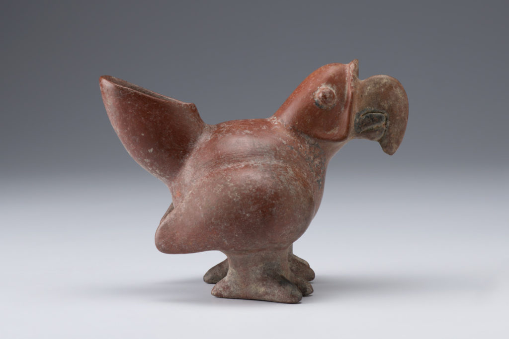 A ceramic sculpture of a parrot.