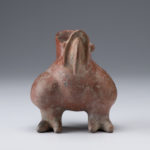 Front view of a reddish-brown ceramic vessel shaped like a parrot.
