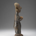 Side view of ceramic figure of a woman.