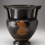 Back of ceramic vessel shows a young woman, painted reddish-brown, running and looking over her shoulder.