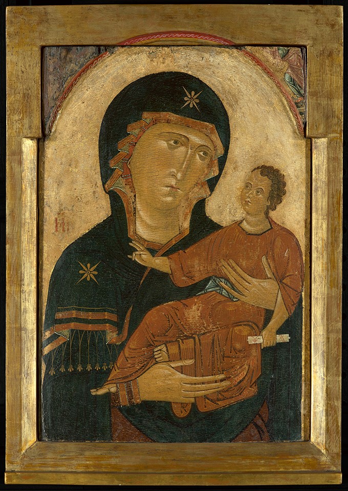 A painting of the Virgin Mary holding the infant Jesus, with a gold leaf background and frame.