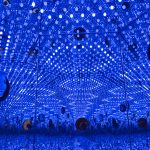 NCMA interns Meredith Wilson and Olivia Briere peer inside a sculpture entitled Light of Life by Yayoi Kusama
