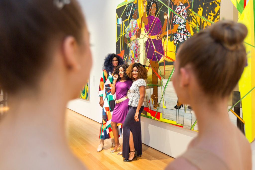 Women posed in front of Three Graces by Mickalene Thomas