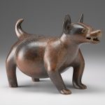 Angled view of a brown and red ceramic sculpture shaped like a dog.