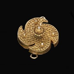 small gold disc shaped ornament with granules