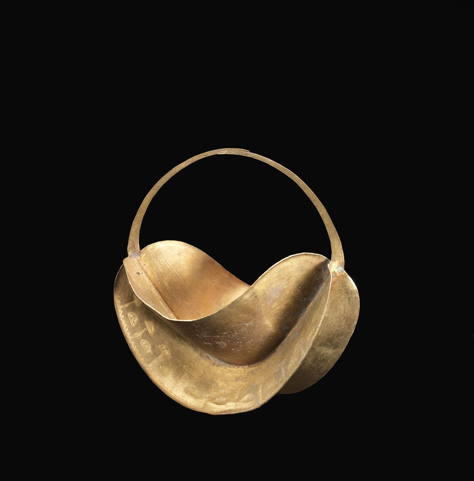 Earring (dibé) Close up of large gold twisted hoop earring