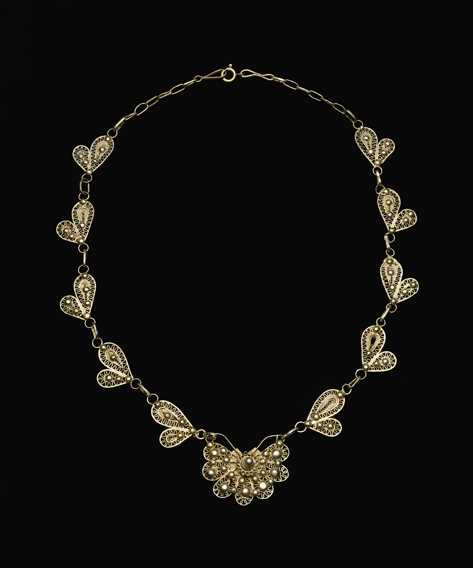 Stylized Butterfly Necklace a gold necklace with large pendant in the middle and small wing shaped pendants around it