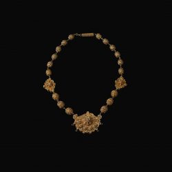 gold necklace with three pendants and other circular beads
