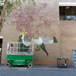 Installation of the mural &quot;Summer’s Where You’ll Find Me&quot; on East Building by artist Louise Jones.