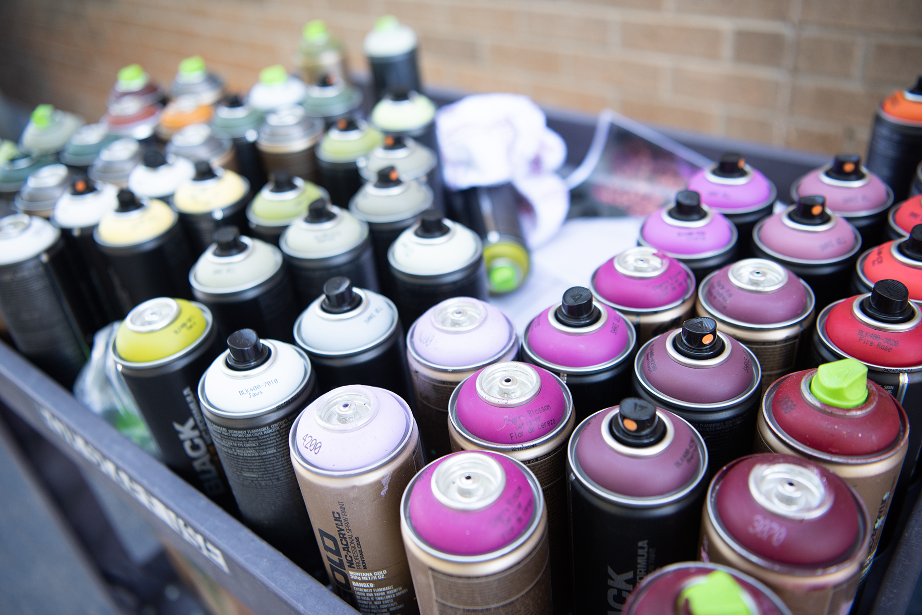 DI25731-05 an array of spray paints used as materials for a mural