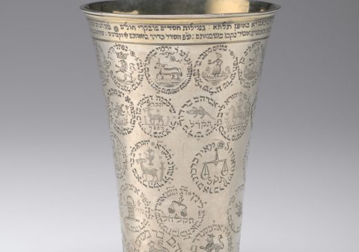 A silver, horn-shaped banquet cup that is engraved with the names of the members of a burial society’s members and their personal emblems.