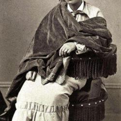 black and white photo of sculptor Edmonia Lewis showing her seated in a chair