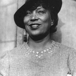 black and white photo of writer and anthropologist Zora Neale Hurston wearing a hat