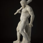 A white marble sculpture of a nude, bearded male figure holding a club over his shoulder. His weight is supported by a tree trunk behind him. Alternate view.