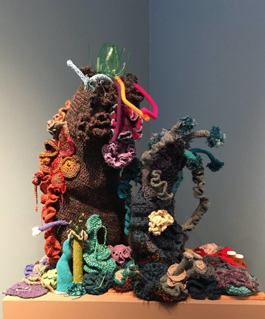 A variety of crocheted items that form a coral reef