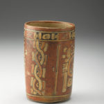 Rear view of a red ceramic vase.