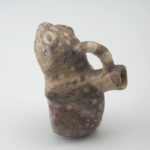Side view of ceramic vessel shaped like a frog.