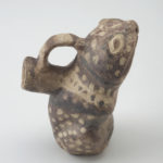 Side view of ceramic vessel shaped like a frog.