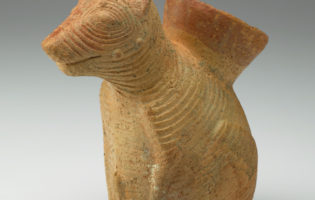 A ceramic vessel shaped like a dog.