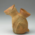 Side view of a ceramic vessel shaped like a hairless dog.