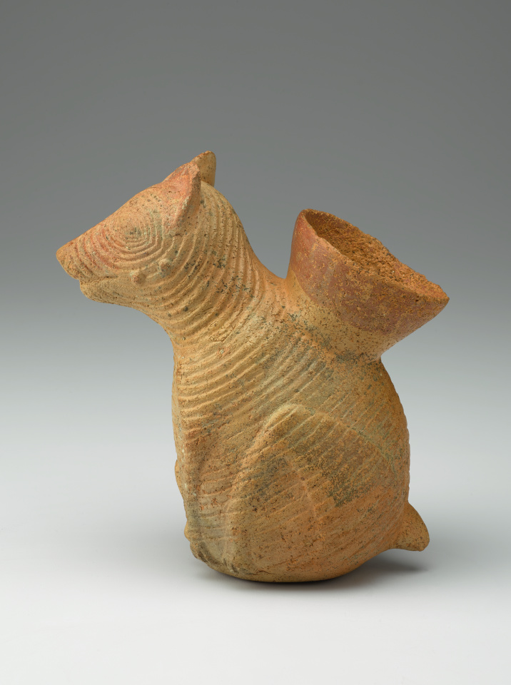 A ceramic vessel shaped like a dog.