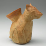 Angled view of a ceramic vessel shaped like a hairless dog.