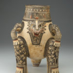 A ceramic jug with the head, legs, and tail of a jaguar.