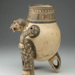 Side view of a painted terracotta vessel shaped like a crouching animal.
