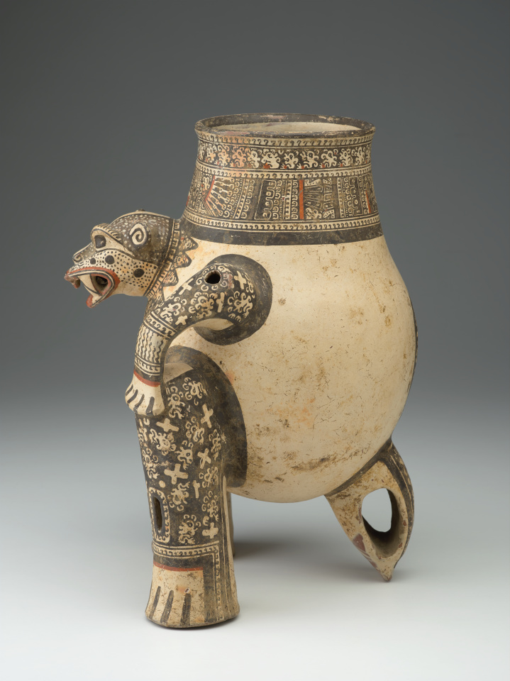 A ceramic jug with the head, legs, and tail of a jaguar.