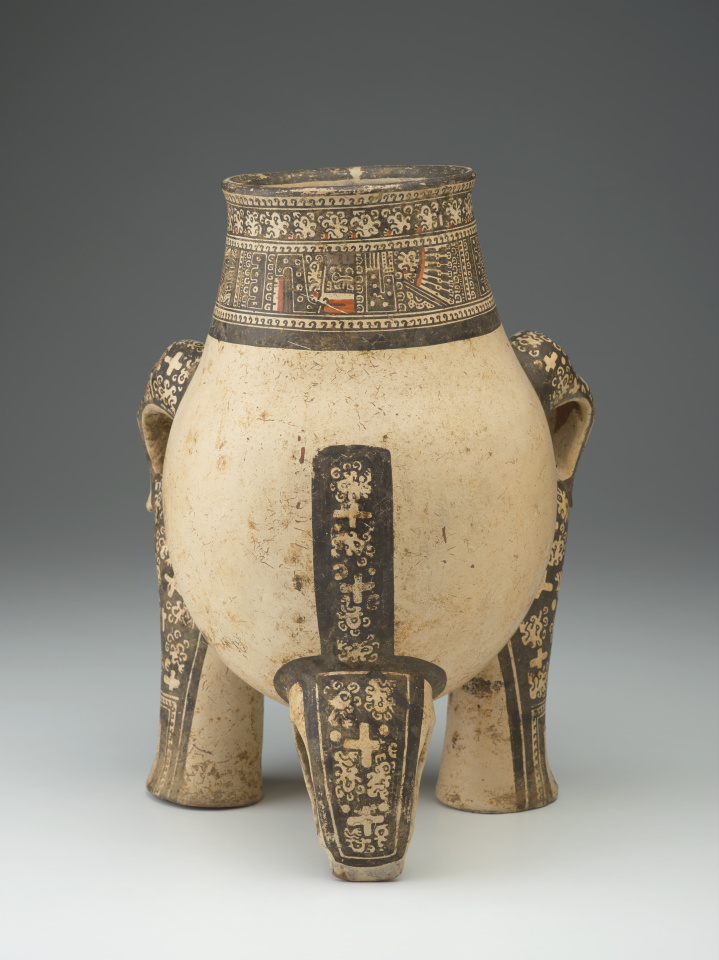 A ceramic jug with the head, legs, and tail of a jaguar.