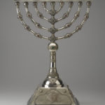 A silver Hanukkah menorah. A silver Hanukkah menorah. View of reverse.