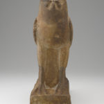 A stone sculpture of a falcon. Alternate view.