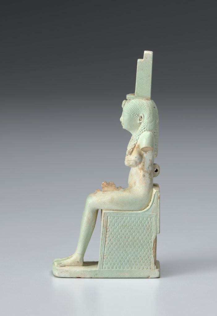 A small sculpture of the Egyptian goddess Isis with remnants of the infant body of Horus.