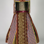 A vibrant African dance costume made from cloth, wood, and cowrie shells.