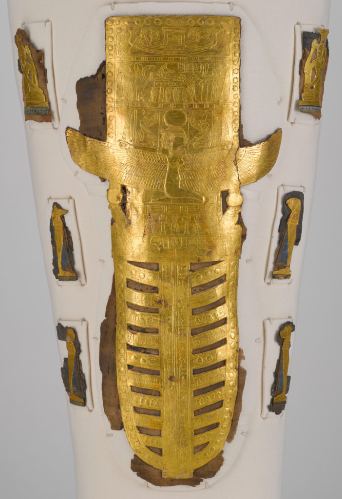 A white, linen-wrapped mummy covering with a gold Egyptian mask and gold accents on the chest, legs, and feet.