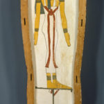 A wooden coffin shaped like a human body, with ancient Egyptian symbols and deities painted on its surface. Reverse of front section.