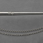 The matching pointer, the tip is shaped like a hand pointing its finger and a chain extends from the end.