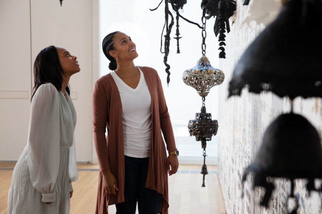 two women look at an installation