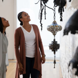 two women look at an installation
