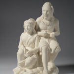 A white marble sculpture of a father and daughter sitting. The daughter sits slightly lower than the father while she works on a weaving project. Her father is carving an arrowhead. A slaughtered deer lies at their feet.