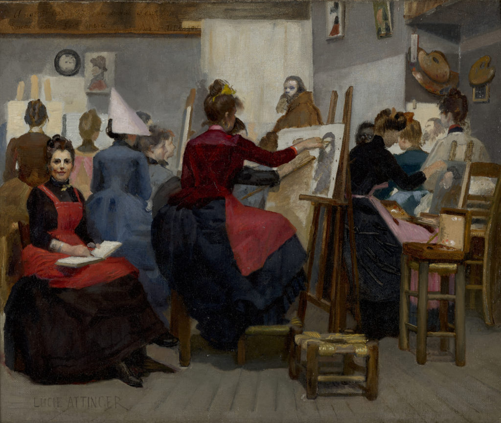A painting depicting an all-women painting class. The women are dressed in dark- colored, long-sleeve dresses with aprons and are seated on stools in front of easels. A bearded man wearing brown clothing is shown in the background, posing as a model for the class. The woman in the red apron who is facing the viewer is Lucie Attinger, the artist who created this painting.
