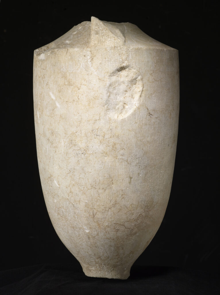 A cylinder-shaped marble vessel with a tapered top and a tapered base. The center of the vessel is engraved with the design of a seated man and a standing woman shaking hands.